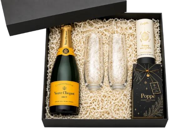 Black box holding a bottle of champagne, two glass flutes and gourmet popcorn on cream crinkle fill